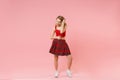 Pretty young blonde woman girl in red sexy clothes isolated on pastel pink background studio portrait. People sincere Royalty Free Stock Photo