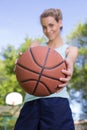 pretty young blonde woman offering ball