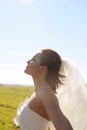 Pretty young bride profile portrait on a field, sunny backlite Royalty Free Stock Photo