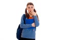 Pretty young brunette student girl with blue backpack isolated on white background Royalty Free Stock Photo