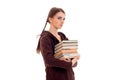 Pretty young brunette student girl with a lot of books in hands isolated on white background Royalty Free Stock Photo