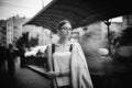 Pretty young brunette woman dressed casual posing outdoor with leather handbag. black and white photo Royalty Free Stock Photo