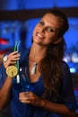 Pretty young brunette woman drinking cocktail in bar Royalty Free Stock Photo