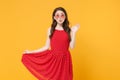 Pretty young brunette woman girl in red summer dress, eyeglasses posing isolated on yellow background studio. People Royalty Free Stock Photo