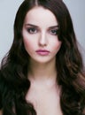 Pretty young brunette woman with hair style like cute doll hairstyle waves, glamorous makeup