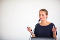 Pretty, young business woman giving a presentation in a conference/meeting setting Royalty Free Stock Photo