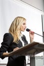 Pretty, young business woman giving a presentation in a conference Royalty Free Stock Photo