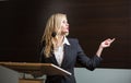 Pretty, young business woman giving a presentation in a conference Royalty Free Stock Photo