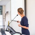 Pretty, young business woman giving a presentation in a conference Royalty Free Stock Photo