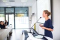 Pretty, young business woman giving a presentation in a conference Royalty Free Stock Photo