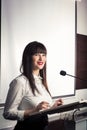 Pretty, young business woman giving a presentation in a conference Royalty Free Stock Photo