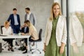 Young business woman standing in the office in front of her team Royalty Free Stock Photo