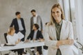 Young business woman standing in the office in front of her team Royalty Free Stock Photo