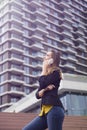 Young business woman uses cellphone at the street against office building Royalty Free Stock Photo