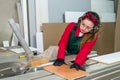 Pretty and young carpentry worker sawing wooden plank Royalty Free Stock Photo