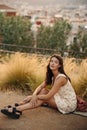 Pretty young caucasian woman looking at camera, relaxing sitting outdoors meeting sunset. Royalty Free Stock Photo