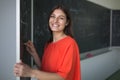 Pretty, young college student writing on the chalkboard Royalty Free Stock Photo