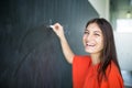 Pretty, young college student writing on the chalkboard Royalty Free Stock Photo