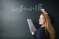 Pretty, young college student writing on the chalkboard Royalty Free Stock Photo