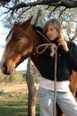 Pretty young cowgirl with a horse Royalty Free Stock Photo