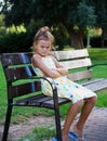 Pretty young eurupean girl looking angry or upset is sitting on the bench in the park. 2 Royalty Free Stock Photo