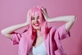 Pretty young female attractive look pink wig stylish clothes pink background unaltered