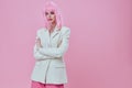 Pretty young female attractive look white blazer pink wig color background unaltered Royalty Free Stock Photo
