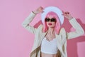 Pretty young female attractive look white blazer pink wig pink background unaltered Royalty Free Stock Photo