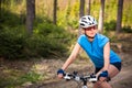 Pretty, young female biker outdoors on her mountain bike Royalty Free Stock Photo