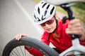 Pretty, young female biker outdoors on her mountain bike Royalty Free Stock Photo