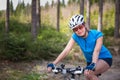 Pretty, young female biker outdoors on her mountain bike Royalty Free Stock Photo