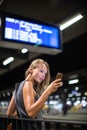 Pretty, young female commuter waiting for her daily train Royalty Free Stock Photo