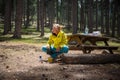 Pretty, young female hiker making breakfast on a camp site Royalty Free Stock Photo