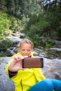 Pretty, young female hiker taking a selfie while outdoors Royalty Free Stock Photo