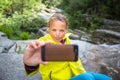 Pretty, young female hiker taking a selfie while outdoors Royalty Free Stock Photo