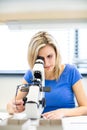 Pretty, young female optician/optometrist measuring new glasses