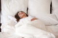 Pretty young female sleeping well in white cozy bed Royalty Free Stock Photo