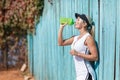 Pretty young female tennis player drinking water eyes closed. Royalty Free Stock Photo