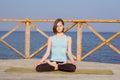 Pretty young fit woman doing yoga exercises on the summer beach Royalty Free Stock Photo