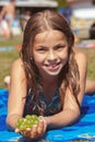 Pretty young girl on the beach with grape Royalty Free Stock Photo