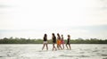 young girl on the beach, pretty girl walking on the beach, young woman running on the beach, backside view