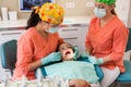 Dental checkup, being given to young girl, by female dentist with assistant Royalty Free Stock Photo