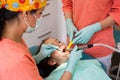Dental checkup, being given to young girl, by female dentist with assistant Royalty Free Stock Photo