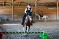 Pretty young girl doing equestrian show jumping on her pony in a farm Royalty Free Stock Photo