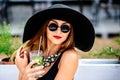 Pretty young girl drink cold coctail outdoor in beach cafe Royalty Free Stock Photo