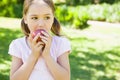 Pretty young girl eating apple in park Royalty Free Stock Photo