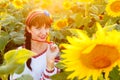 Pretty young girl embrodery on a sunflower plant Royalty Free Stock Photo