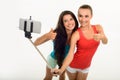 Pretty young girl-friends making selfie with fingers-up. Royalty Free Stock Photo