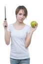 Pretty young girl with green apple and knife Royalty Free Stock Photo