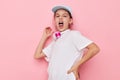 pretty young girl headphones in a white t-shirt and a cap childhood unaltered Royalty Free Stock Photo